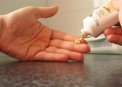 photograph of someone applying sunscreen