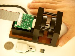 Scientists are developing a portable device that can measure a person's radiation exposure in minutes using radiation-induced changes in the concentrations of certain blood proteins. This image shows a magneto-nanosensor chip reader station, chip cartridge, and chip. (Credit: S. Wang)