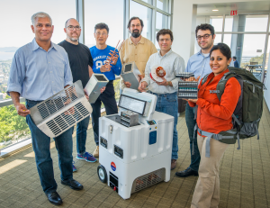LBNL Institute for Globally Transformative Technologies research team with prototype vaccine fridge and backpack for developing countries. (Berkeley Lab / Roy Kaltschmidt)