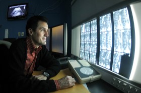 Dr. Marcus Maydew, radiologist from Creighton University, reviews an x-ray (Offutt Air Force Base).